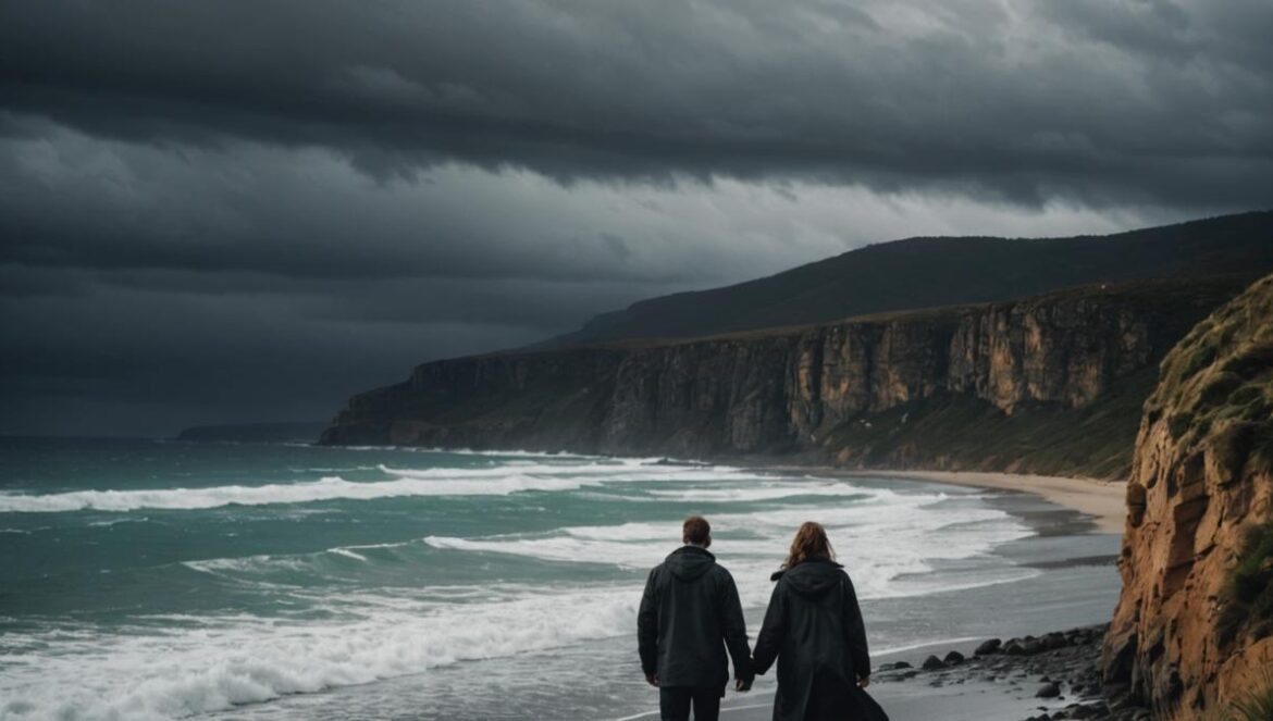 ‘The Survivors’ arrasa en Netflix sin ruido: ¿por qué todos están enganchados? A dramatic coastal town in Tasmania, stormy sky over rugged cliffs and beach, two main characters (a man and a woman) walking pensively along the shoreline, photorealistic editorial style, moody lighting with dark clouds and wet sand, somber and mysterious atmosphere, main subjects centered and in sharp focus.